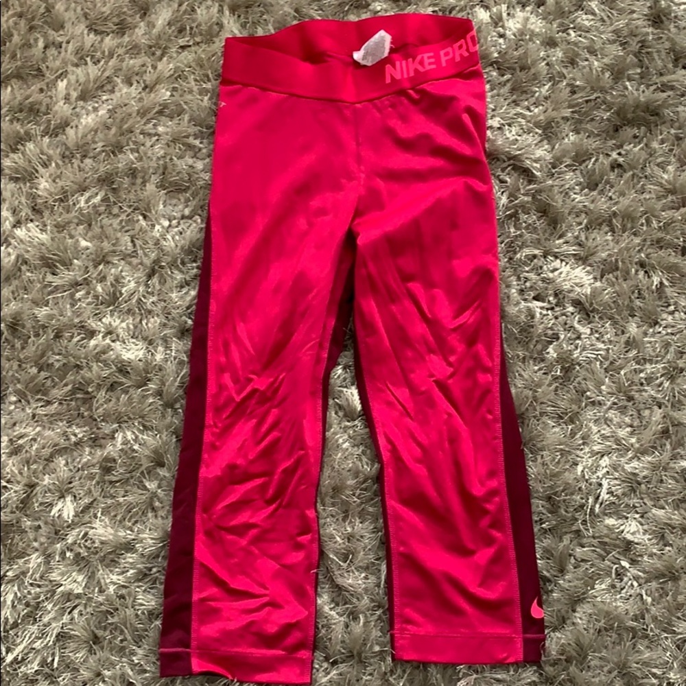 Pink and maroon Nike Pro Capri pants